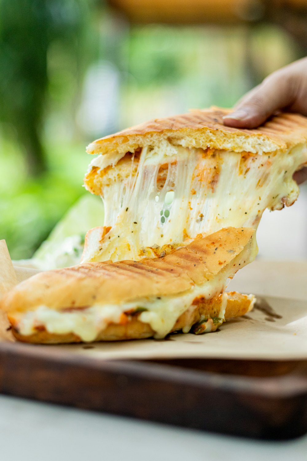 Stock photo of a grilled cheese with a cheese pull